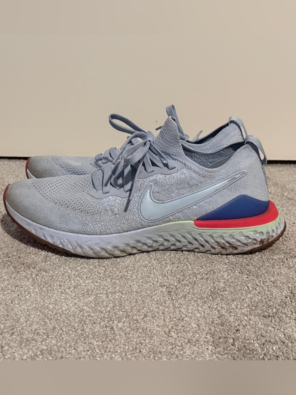 Nike Light Gray Flyknit Running Shoes with Blue & Red Heel Accents